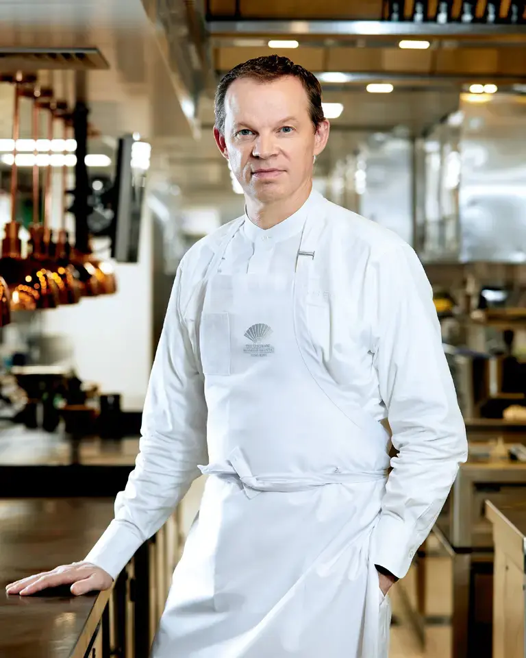 Chef Richard Ekkebus in the kitchen in chef whites.