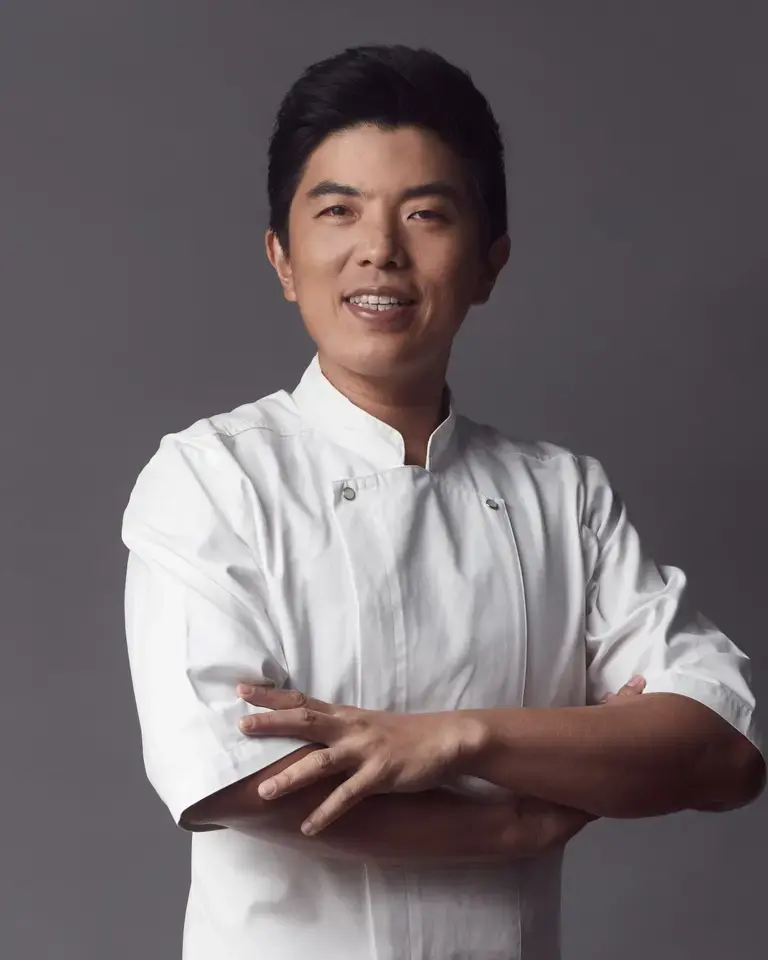 Chef Thitid 'Ton' Tassanakajohn with his arms folded.