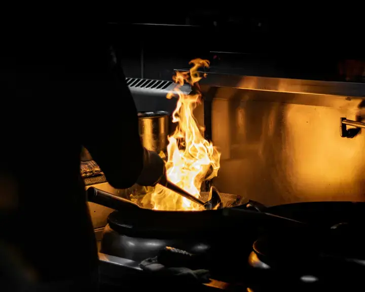 Cooking with flame using a wok