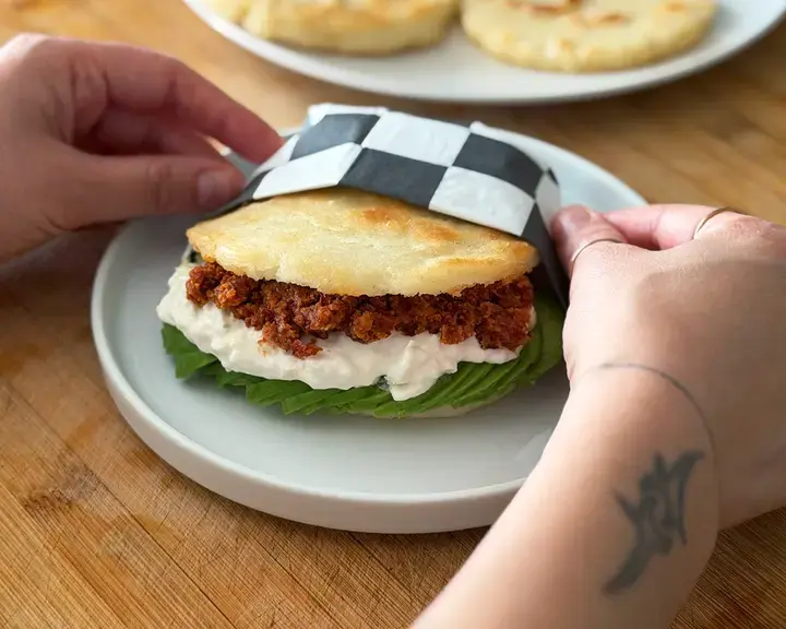 Venezuelan arepa with avocado, burrata and red pesto.