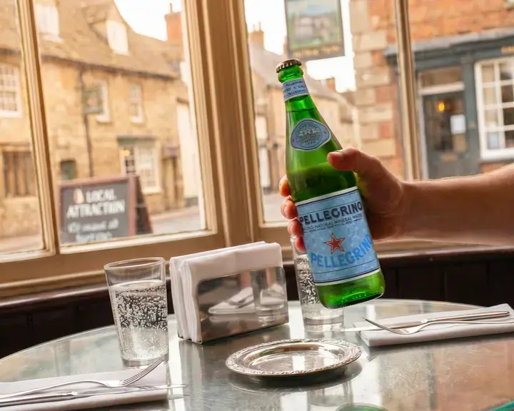 S.Pellegrino at a restaurant table in an English village.
