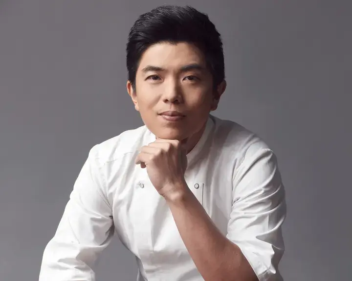 Chef Ton, resting his chin on his hand.