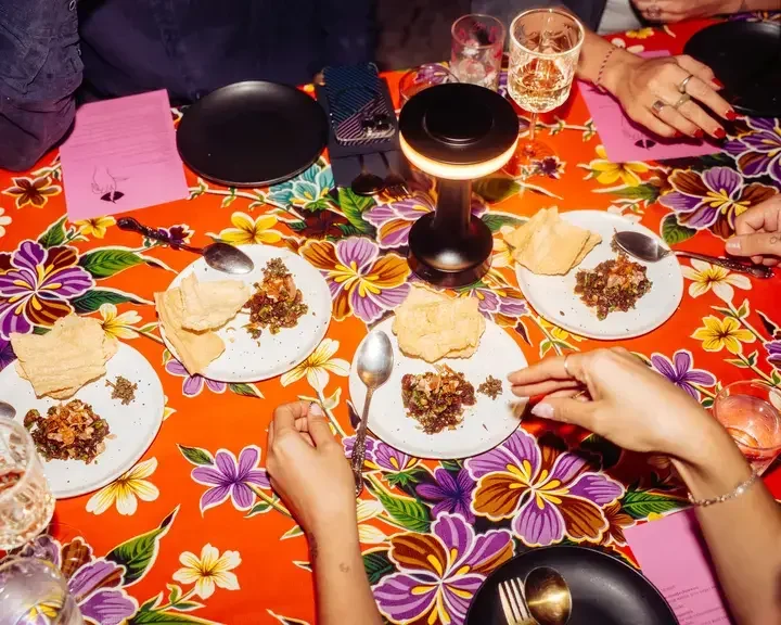 Dinner table with bright tablecloth at Haawm in Bangkok.