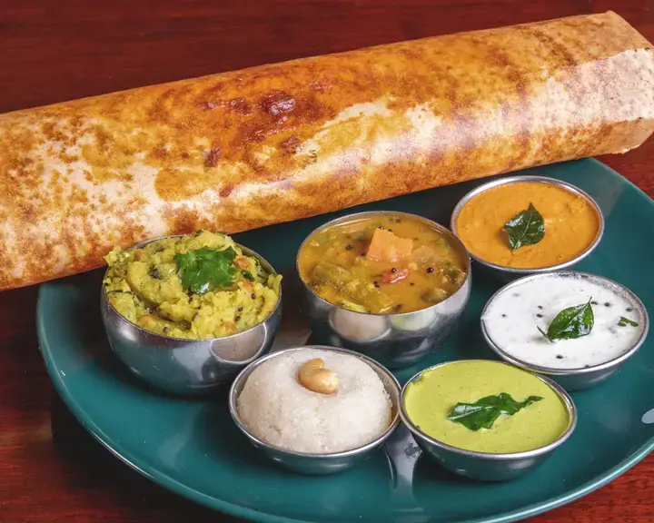 Dosa served with some typical Indian sauces.